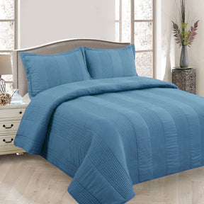 Arlington blue pintuck quilted coverlet set on a Queen bed with matching pillowcases