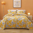 Yellow lightly quilted cotton coverlet set with two pillow shams on a queen bed