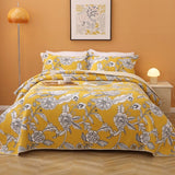 Yellow lightly quilted cotton coverlet set with two pillow shams on a queen bed