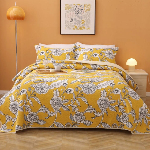 Yellow lightly quilted cotton coverlet set with two pillow shams on a queen bed