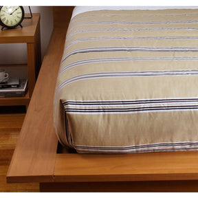 Latte striped reversible comforter with channel quilting on a Super King bed