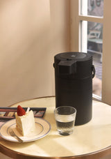 Side view of 2.5 L black stainless steel air press pot showing pour spout and carry handle