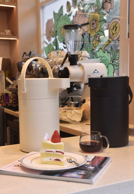 Air press pot beverage dispenser with wide mouth opening showing stainless steel inner chamber