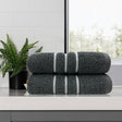 Two charcoal 650 GSM cotton bath towels, 68 x 137 cm, folded to show the contrasting dobby stripe border