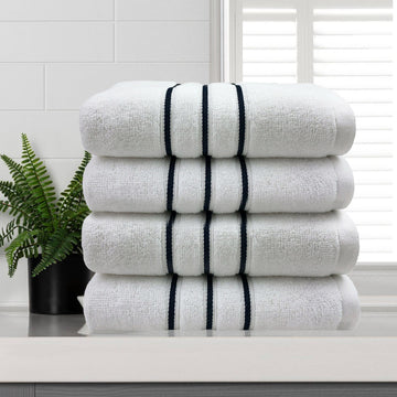 Four white 650 GSM cotton hand towels, 40 x 60 cm, folded to show the contrasting dobby stripe border