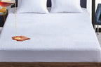 Newgale coral fleece waterproof mattress protector double on a made bed