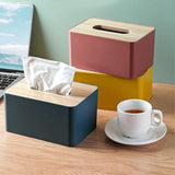 Blue tissue box sitting on a bedside table beside a lamp
