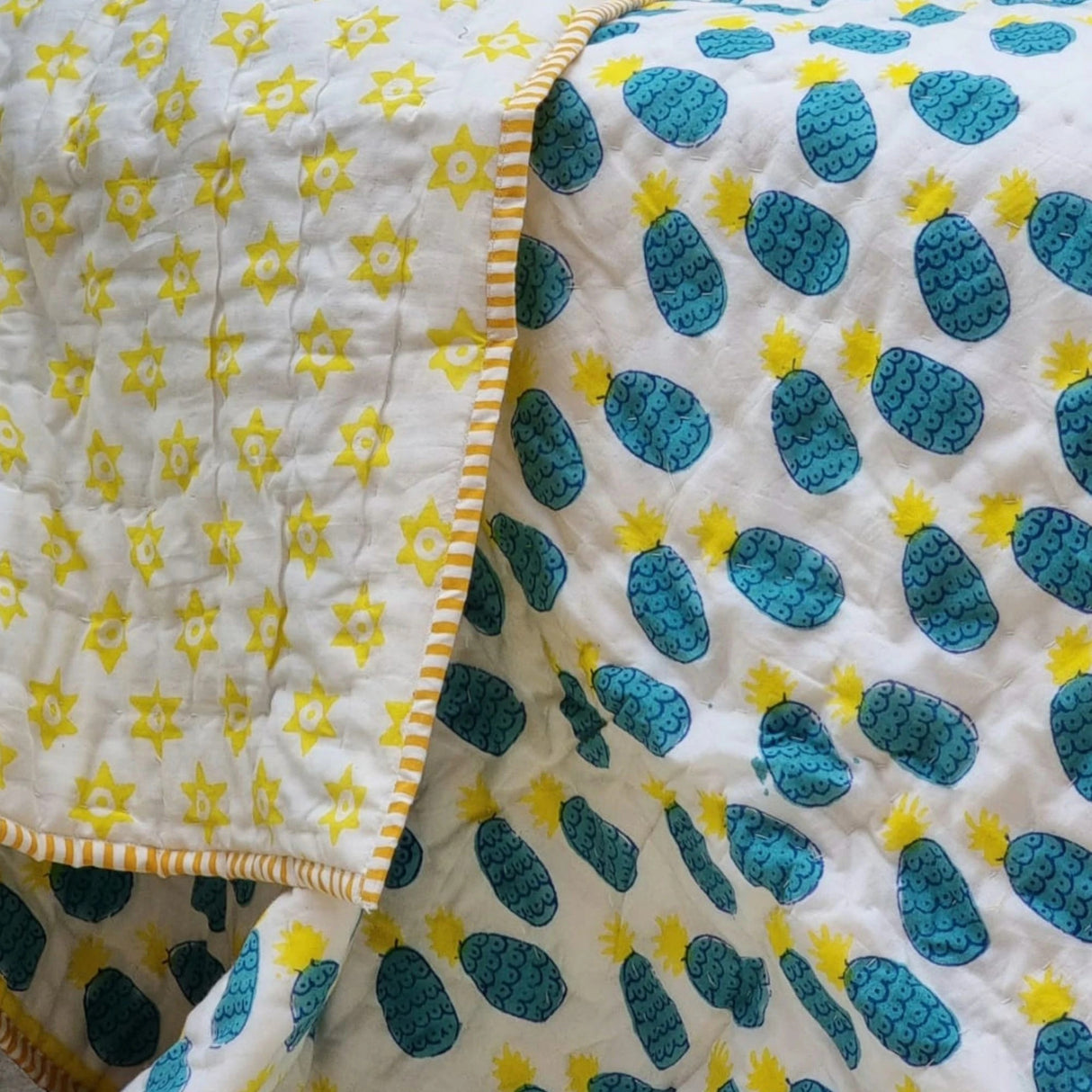 Organic cotton reversible baby quilt in blue pineapple print