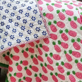 Organic cotton reversible baby quilt in pink pineapple print