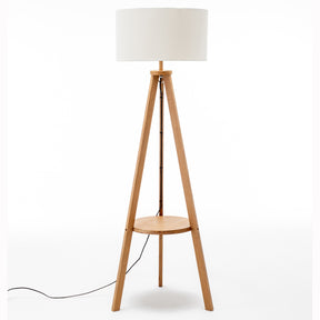 Natural wooden tripod floor lamp with round shelf and off white linen shade