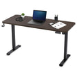 Reid walnut electric standing desk with black frame in a home office