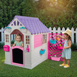 Garden playhouse with pink fence