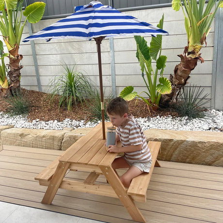 Wooden sand and water table with umbrella