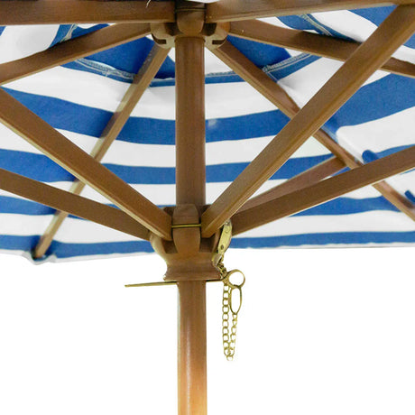 Wooden sand and water table with umbrella outdoors