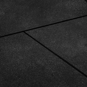 Large coverage of black bevelled edge rubber gym floor tiles in a commercial gym