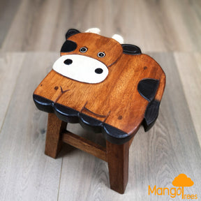 Children's wooden animal stool in a cow design