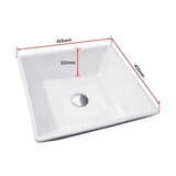 White square ceramic bench top basin in a modern bathroom setting