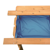 Kids using the sand and water picnic table
