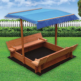 Children playing in wooden sandpit with canopy