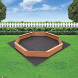 Children playing in octagonal wooden sandpit