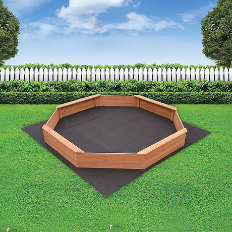 Children playing in octagonal wooden sandpit