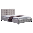 Concord queen bed in beige linen with a button tufted headboard in a chic bedroom