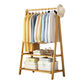 Berri natural bamboo portable clothes rack with hanging rail and side hooks in a bedroom