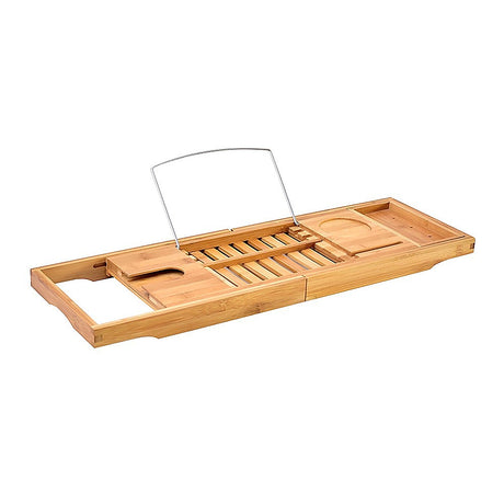 Extendable bamboo bath caddy tray with soap shelf resting across a bathtub