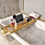 Bamboo bath caddy holding a wine glass, candles and a phone