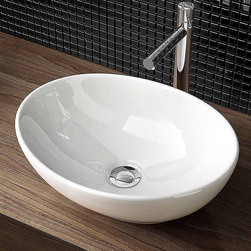 White oval ceramic above counter basin, angled view