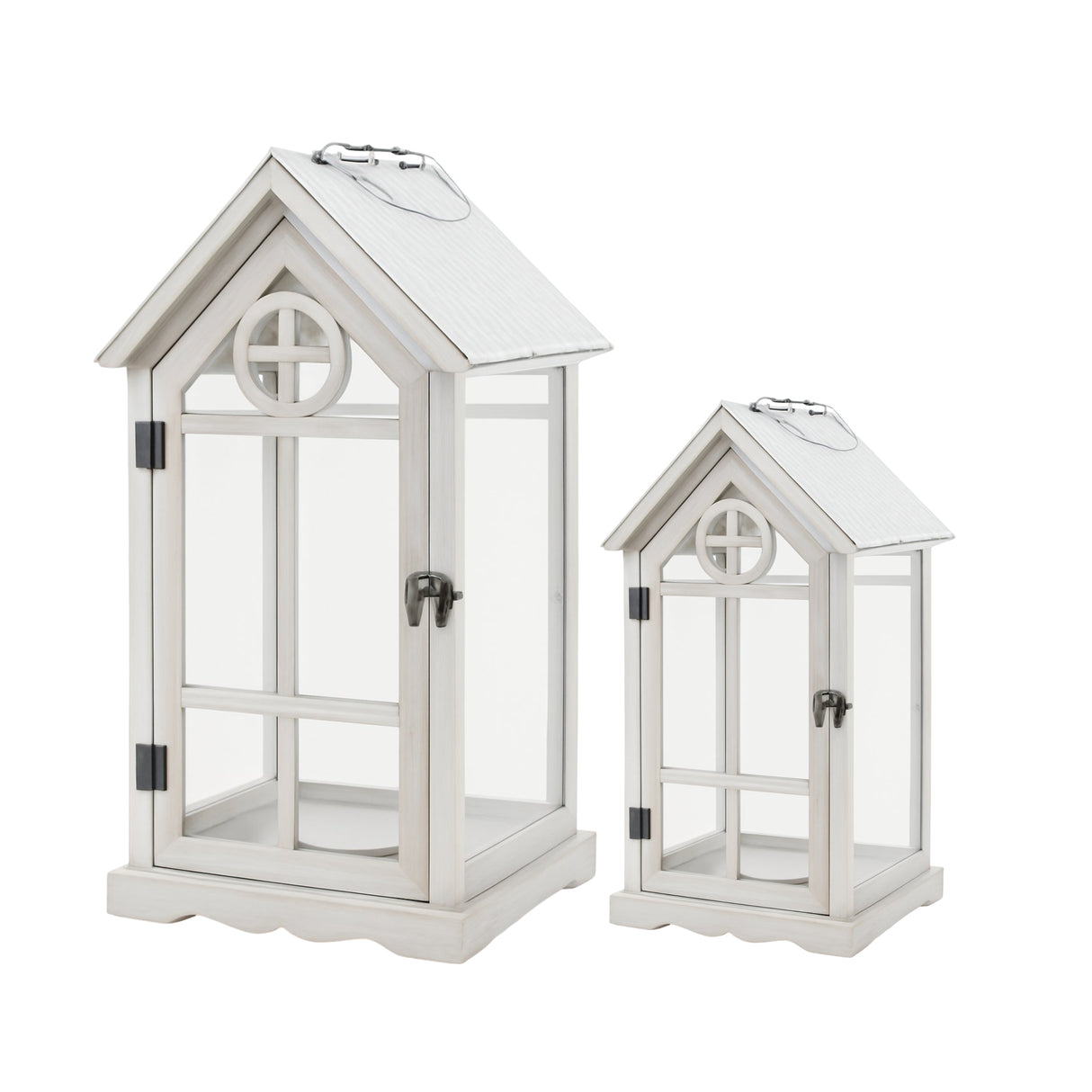 Set of two white house shaped wooden lanterns with glass panels and pitched roofs