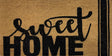 Atherton Sweet Home coir door mat in black on natural at a front door, 90cm