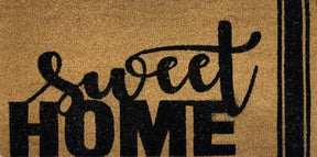 Atherton Sweet Home coir door mat in black on natural at a front door, 90cm