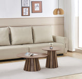 Walnut veneer round side table styled beside a sofa in a living room