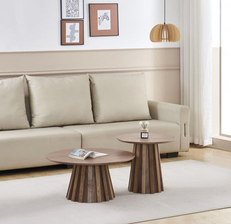 Walnut veneer round side table styled beside a sofa in a living room