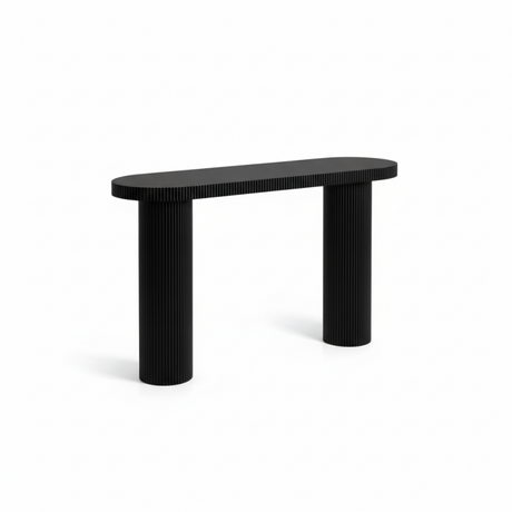 Black console table styled in an entryway with decor