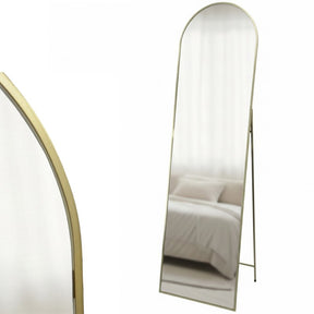 Lorne gold metal framed cheval floor mirror in a contemporary bedroom