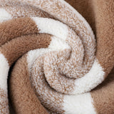 Green striped cotton bath towel hanging in a bathroom