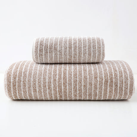 Brown striped cotton towels folded and stacked showing woven stripe detail