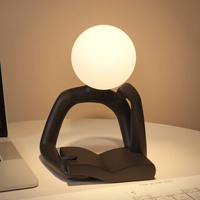 Adele black book reader LED desk lamp on a study desk