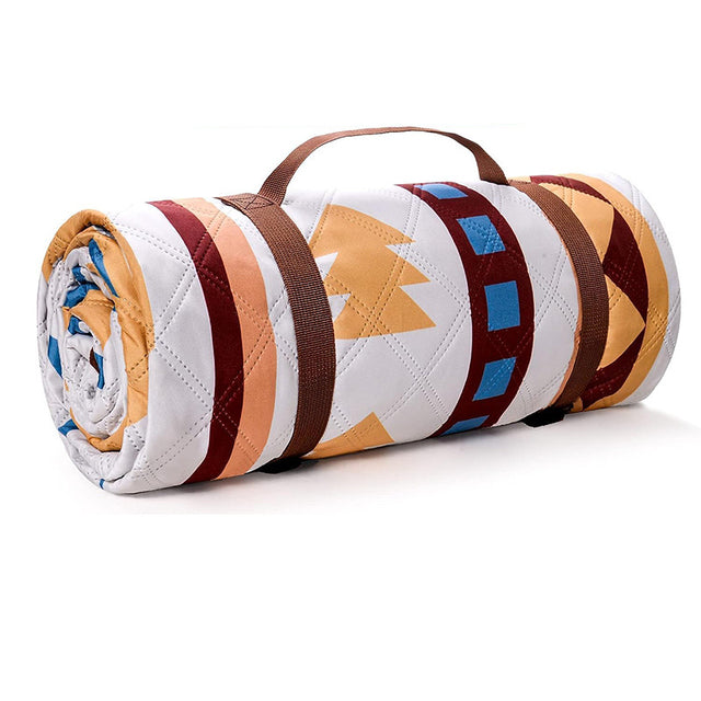 Cartmel traditional geometric picnic mat 200 x 200cm laid on grass in vibrant multicolour polyester with rolled storage bag