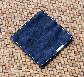 Milawa navy blue hand embroidered ramie linen tea coasters set of four on a table