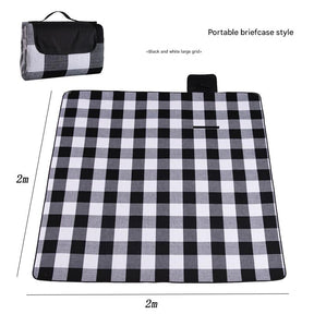 Hawkshead picnic blanket 200 x 200cm in black and white grid print laid on grass with soft fabric top and water resistant PEVA backing