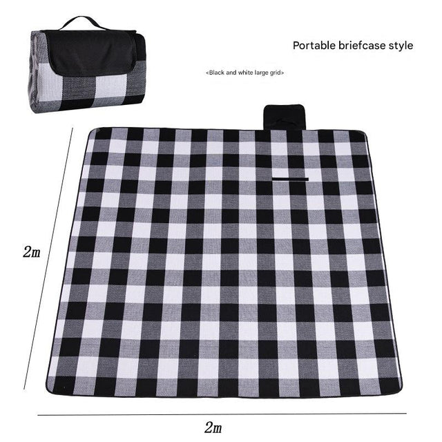 Hawkshead picnic blanket 200 x 200cm in black and white grid print laid on grass with soft fabric top and water resistant PEVA backing