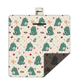 Hawkshead picnic blanket 200 x 200cm in dinosaur print laid on grass with soft fabric top and water resistant PEVA backing