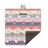 Hawkshead picnic blanket 200 x 200cm in musical bunny print laid on grass with soft fabric top and water resistant PEVA backing