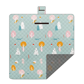 Hawkshead picnic blanket 200 x 200cm in green mood print laid on grass with soft fabric top and water resistant PEVA backing