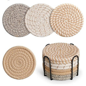 Cheshunt khaki woven cotton coasters set of eight with black metal holder on a table