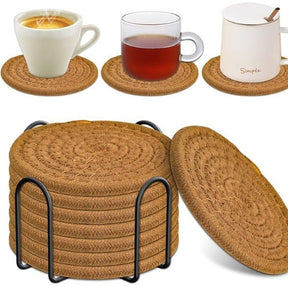 Cheshunt brown woven cotton coasters set of eight with black metal holder on a dining table