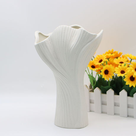 White sculptural ceramic vase with wide fluted opening